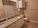 Functional bathroom with a double vanity, ample storage, granite countertop, and neutral-colored walls at 2755 Via Capri Dr # 1215, Clearwater, FL 33764