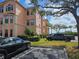 Condominium exterior elevation with parking, sidewalks, trees, and landscaping at 2755 Via Capri Dr # 1215, Clearwater, FL 33764