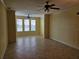 Spacious living room with tile floors, ceiling fans, and large windows for plenty of natural light at 2755 Via Capri Dr # 1215, Clearwater, FL 33764