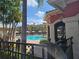 Community pool area with lounge chairs, sun umbrellas, and tropical landscaping at 2755 Via Capri Dr # 1215, Clearwater, FL 33764