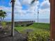 Picturesque water view featuring a wooden pier, lush grass, and a distant bridge at 2755 Via Capri Dr # 1215, Clearwater, FL 33764