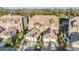 An aerial view of townhomes featuring attached garages, manicured landscaping, and proximity to lush green trees at 2786 Countryside Blvd # 2, Clearwater, FL 33761