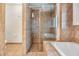 Bathroom with a tiled walk-in shower, tiled floors, and soaking tub at 2786 Countryside Blvd # 2, Clearwater, FL 33761