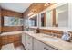 Bathroom featuring double vanity, soaking tub, decorative tile, and shuttered window at 2786 Countryside Blvd # 2, Clearwater, FL 33761