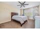 Bedroom with a ceiling fan, window with shutters, and carpet flooring at 2786 Countryside Blvd # 2, Clearwater, FL 33761