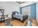 Bedroom featuring stylish design, including blue accent wall, desk and chair, and a large window at 2786 Countryside Blvd # 2, Clearwater, FL 33761