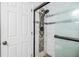 Bathroom showcases a glass-enclosed shower, white door and neutral paint at 2786 Countryside Blvd # 2, Clearwater, FL 33761