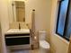 Contemporary bathroom featuring a floating vanity, modern toilet, and stylish mirror at 29318 Whipporwill Ln, Wesley Chapel, FL 33543