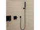 Modern shower with sleek black fixtures and tiled walls at 29318 Whipporwill Ln, Wesley Chapel, FL 33543