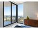 Bedroom with water views from a large window and a stylish wood dresser at 301 1St S St # 2104, St Petersburg, FL 33701