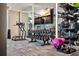 Fitness center with dumbbell rack, television screen, and other workout equipment in a mirrored space at 301 1St S St # 2104, St Petersburg, FL 33701