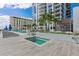 Elevated condo rooftop deck featuring a jacuzzi, a larger pool, and distant city views at 301 1St S St # 2104, St Petersburg, FL 33701