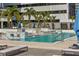 Relaxing community pool with in-pool lounge area, poolside cabanas and palm trees at 301 1St S St # 2104, St Petersburg, FL 33701