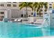 Luxury pool with lounge chairs, waterfall features, and lush palm trees for a resort-style experience at 301 1St S St # 2104, St Petersburg, FL 33701