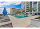 Luxury rooftop pool with lounge chairs, umbrellas, and stunning city views at 301 1St S St # 2104, St Petersburg, FL 33701