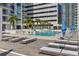 Relaxing rooftop pool deck featuring lounge chairs, umbrellas, and city views at 301 1St S St # 2104, St Petersburg, FL 33701