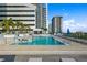 Inviting rooftop pool with clear blue water, modern seating, and beautiful cityscape panorama at 301 1St S St # 2104, St Petersburg, FL 33701