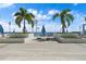 Tranquil pool deck featuring palm trees, lounge chairs, umbrellas and beautiful city views at 301 1St S St # 2104, St Petersburg, FL 33701