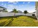 Fenced backyard with healthy lawn and some shady spots at 310 Blackrock Ln, Apollo Beach, FL 33572