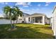 Spacious fenced backyard with tropical landscaping and screened patio at 310 Blackrock Ln, Apollo Beach, FL 33572