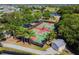 Aerial view of multiple, well-maintained, fenced basketball courts at this community surrounded by lush landscaping at 310 Blackrock Ln, Apollo Beach, FL 33572