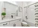 Modern bathroom with white subway tile, marble countertop, and dark fixtures at 310 Blackrock Ln, Apollo Beach, FL 33572