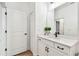 Bright bathroom featuring white marble countertop, dark hardware and wood-look floors at 310 Blackrock Ln, Apollo Beach, FL 33572