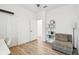 Bedroom featuring wood floors, a ceiling fan, with a soft chair and bookcase at 310 Blackrock Ln, Apollo Beach, FL 33572