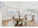 Bright dining area with a round table, four chairs, and modern decor, across from a kitchen at 310 Blackrock Ln, Apollo Beach, FL 33572