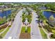 Aerial view of the community's entrance, featuring palm trees, lakes, and lush landscaping at 310 Blackrock Ln, Apollo Beach, FL 33572