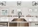 Close up of kitchen island with a stainless steel sink and white countertop at 310 Blackrock Ln, Apollo Beach, FL 33572