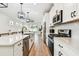 Modern kitchen with stainless steel appliances, white cabinets, and an open layout at 310 Blackrock Ln, Apollo Beach, FL 33572