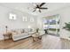 Comfortable living room with a large sectional sofa, sliding glass doors to the patio, and a ceiling fan at 310 Blackrock Ln, Apollo Beach, FL 33572