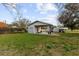 Backyard showcasing an detached garage and car port at 38928 Tall Dr, Zephyrhills, FL 33540