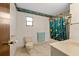 Cozy bathroom includes a shower with colorful tropical fish curtain, a sink, and a toilet at 38928 Tall Dr, Zephyrhills, FL 33540