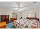 Cozy main bedroom featuring neutral walls, ceiling fan, and views of the front yard at 38928 Tall Dr, Zephyrhills, FL 33540