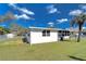 Exterior view of the property highlighting the fenced backyard, and mature trees at 4529 Olive Dr, Zephyrhills, FL 33542