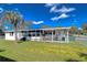 Lush backyard featuring a screen porch and fenced perimeter for privacy and outdoor living at 4529 Olive Dr, Zephyrhills, FL 33542