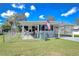 Charming single-story home featuring a fenced yard, covered porch, and an American flag waving proudly at 4529 Olive Dr, Zephyrhills, FL 33542