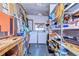 Organized laundry room featuring a washer, dryer, shelving, and workspace at 4529 Olive Dr, Zephyrhills, FL 33542