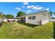 This home boasts a well-maintained lawn, an open patio area, and a screened-in porch, perfect for outdoor living at 4706 Shale Pl, Tampa, FL 33615