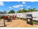 Backyard patio featuring outdoor seating, lush landscaping, and a built-in gas grill at 4706 Shale Pl, Tampa, FL 33615