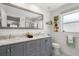 Well-lit bathroom with a double vanity, a large mirror, and a window at 4706 Shale Pl, Tampa, FL 33615