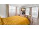 Bright bedroom with plush yellow bedding, large windows, and light neutral curtains at 4706 Shale Pl, Tampa, FL 33615