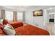 Bedroom featuring two orange beds, TV, and neutral walls with white trim at 4706 Shale Pl, Tampa, FL 33615