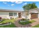 Inviting home featuring manicured landscaping, stone accents, walkway, and a two-car garage at 4706 Shale Pl, Tampa, FL 33615