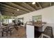 Enjoy this covered patio featuring a bar, picnic table, and entrance to the screened in porch at 4706 Shale Pl, Tampa, FL 33615