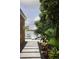 Landscaped backyard with lush tropical plants and a stone walkway leading to the water at 4900 59Th S Ave, St Petersburg, FL 33715