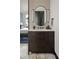 Stylish bathroom featuring a modern vanity, oval mirror, and patterned accent wall at 4900 59Th S Ave, St Petersburg, FL 33715