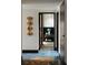 A hallway with blue tile floors and a colorful rug, leading to a modern bedroom at 4900 59Th S Ave, St Petersburg, FL 33715